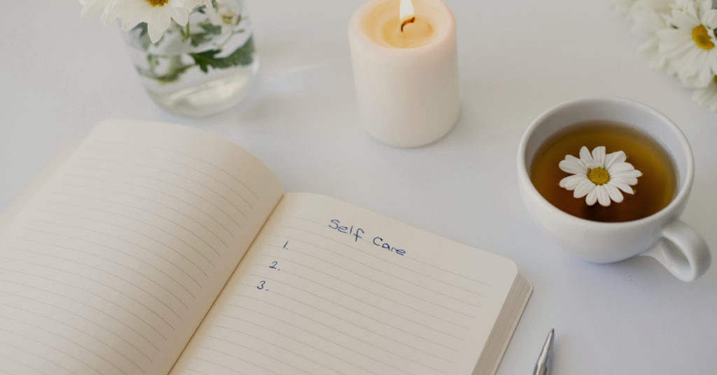 journaling with tea and a candle as a form of self-care